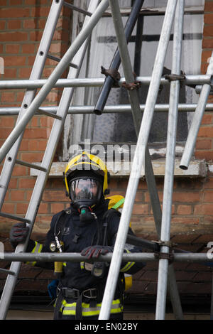 London Fire Brigade (LFB) firefighters attend a roof fire in Herne Hill, south London. Stock Photo