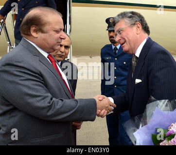 Prime Minister Muhammad Nawaz Sharif being received by Representative of the British Government Ambassador Nicholas Jarrold and Pakistan's High Commissioner to the UK, Syed Ibne Abbas at Heathrow Airport, London, UK on April 24, 2015. Stock Photo