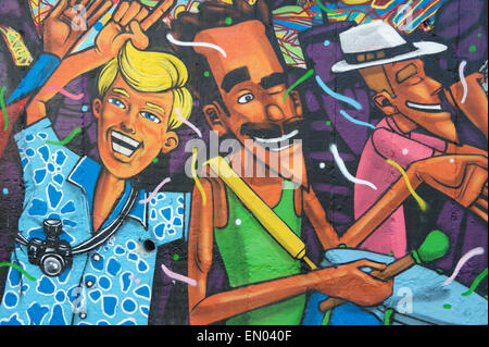 RIO DE JANEIRO, BRAZIL - MARCH 6, 2015: Street art in graffiti depicts happy people celebrating in the lively neighborhood Lapa Stock Photo