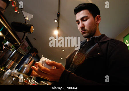 The Hague, Netherlands. 23rd Apr, 2015. A young men is seen preparing an espresso coffee in a cafe in the center of The Hague. Credit:  Willem Arriens/Alamy Live News Stock Photo