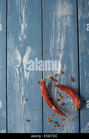 Red Hot Chili Peppers over blue wooden background Stock Photo