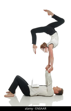 Acrobatic business people doing handstand in pair Stock Photo