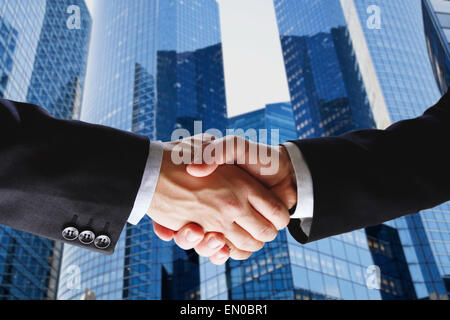 business deal, handshake on modern blue background Stock Photo