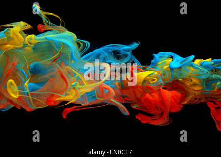 Colorful ink swirling through water Stock Photo