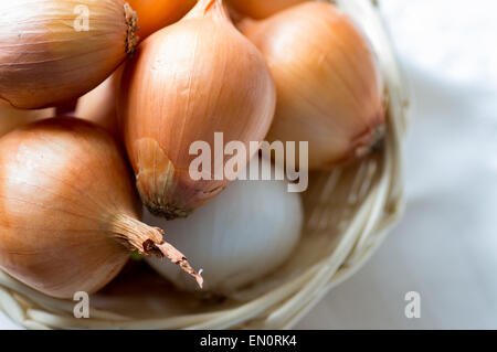 Onion bulbs in basket view from above Stock Photo