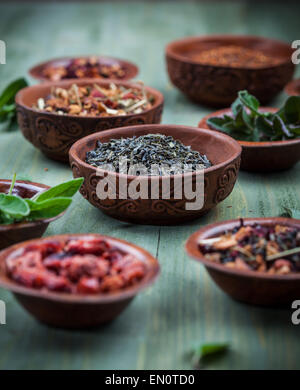 Assortment of dry tea in bowls Stock Photo