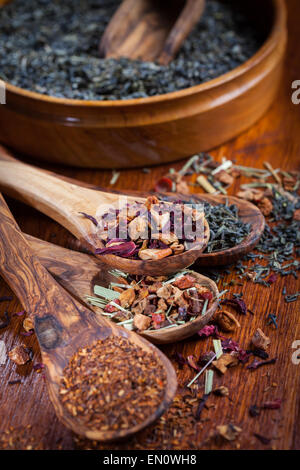 Assortment of dry tea on wooden table Stock Photo