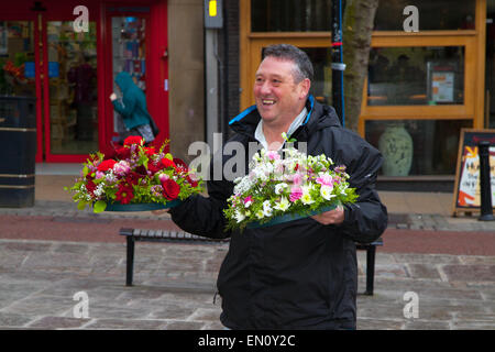 Preston, Lancashire, UK 25th April 2015. Bringing wreaths to mark International Workers Memorial Day event with memorial service, March & rally to acknowledge those killed, injured and made ill through work each year.  The Commemoration and Campaign at Preston Flag market this year is to remember the dead and fight for the living with disease and illness generated by hazardous substances such as Asbestos. Credit:  MarPhotographics/Alamy Live News. Stock Photo