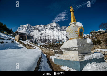 Sagarmatha National Park, Nepal - 9 March 2015: Stupa in Namche Bazaar, with Nupla moutain in the background Stock Photo