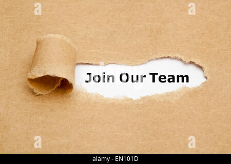 The text Join Our Team appearing behind torn brown paper. Stock Photo