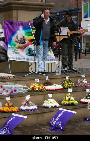 Preston, Lancashire, UK 25th April 2015. Andy Birchall speaker at the International Workers Memorial Day event with memorial service, March & rally to acknowledge those killed, injured and made ill through work each year.  The Commemoration and Campaign at Preston Flag market this year is to remember the dead and fight for the living with disease and illness generated by hazardous substances such as Asbestos. Credit:  MarPhotographics/Alamy Live News. Stock Photo