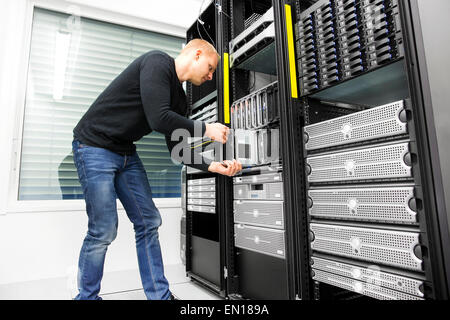IT engineer installs blade server in datacenter Stock Photo