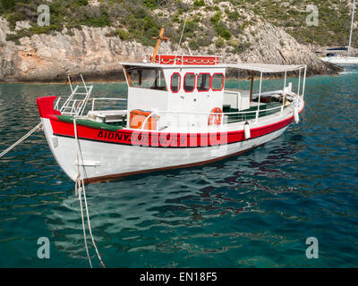 Boat in Porto Vromi bay waters Stock Photo