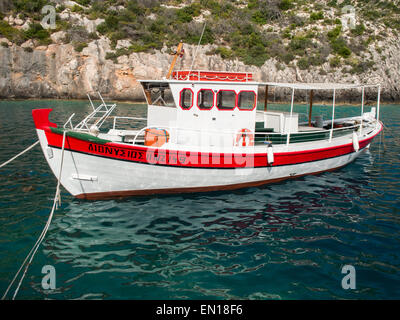 Boat in Porto Vromi bay waters Stock Photo