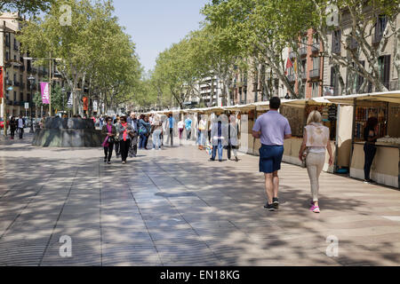 people walking on La Rambla with art and souvenir stalls, Barcelona, Catalonia, Spain Stock Photo