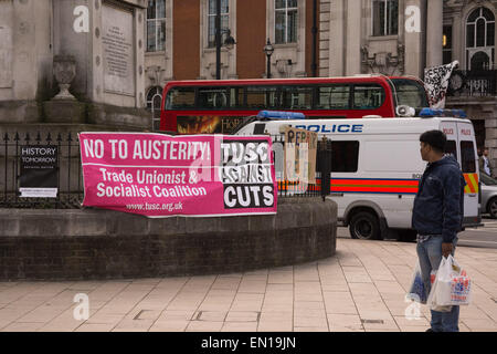 Brixton, London, 25th April 2015 A passer-by looks at banners hanging in Windrush Square as anti-gentrification protesters march through Brixton in London. Credit:  Patricia Phillips/Alamy Live News Stock Photo