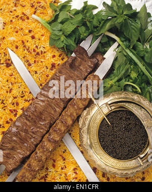 Persian Food: Kebab (Kabab) on a bed of falvoured rice and served with caviar. Stock Photo
