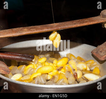 Silk workers, pot of hot water containing the silken cocoons, yellow are Thai, white are Chinese, Chiang Mai, Thailand Stock Photo