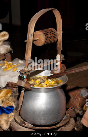 Silk workers, pot of hot water containing the silken cocoons, yellow are Thai, white are Chinese, Chiang Mai, Thailand Stock Photo