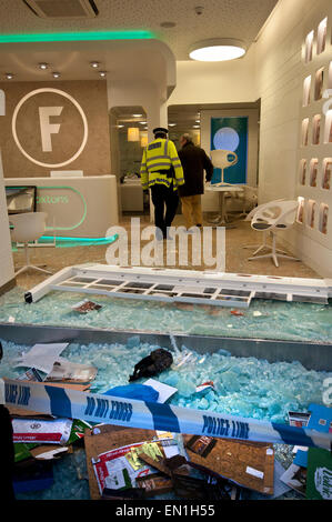 Foxtons Estate Agents window smashed and riot police using tear gas vandalised after Reclaim Brixton event April 25th 2015 Stock Photo