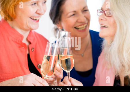 Three Happy Adult Mom Friends Celebrating Something. Stock Photo