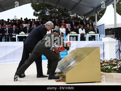 (150425) -- CANAKKALE, April 25, 2015(Xinhua) -- Turkish Minister for EU Affairs Volkan Bozkir(L) presents a bouquet at Turkish memorial service in Canakkale, Turkey, April 25, 2015. Leaders and dignitaries from the UK, Ireland, Australia and New Zealand joined Turkish military delegates to attend Turkish memorial service on Saturday at the 57th Infantry Regiment Memorial, as an event of 100th anniversary of the Gallipoli Battle. (Xinhua/He Canling) Stock Photo