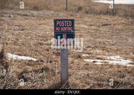 Posted sign on tree in forest forbidding hunting, fishing trapping or  trespassing Stock Photo - Alamy