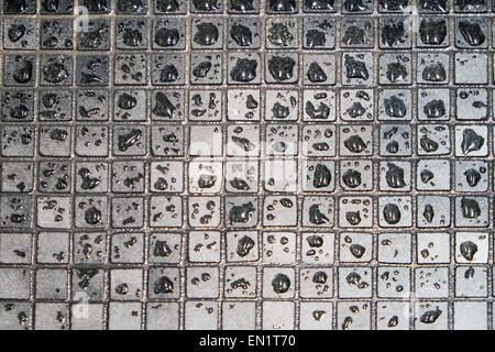 Wet and gray mosaic tiles in a bathroom Stock Photo