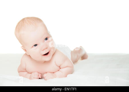 Little boy lying on stomach and smiling Stock Photo