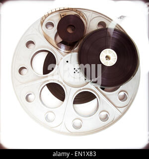 Original old big movie reel for 35 mm film projector film loaded detail on  neutral background Stock Photo - Alamy