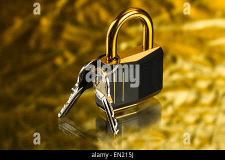 hinged lock with keys on golden background Stock Photo