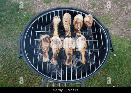 Chicken cooking on a BBQ. Stock Photo