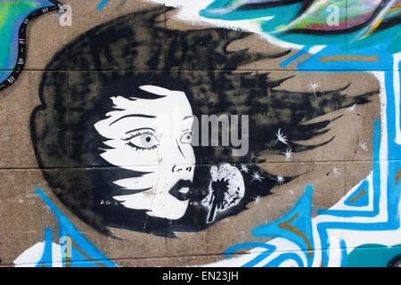 Street art in Brookfield Avenue (off Gloucester Road), Bristol: blowing on a dandelion clock - making a wish Stock Photo