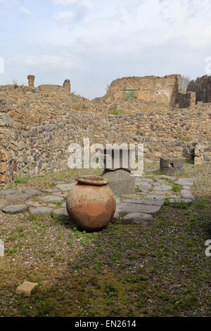 Remains of volcanic rock mills in the Bakery, Pompeii, Italy. Stock Photo