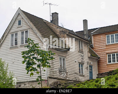 Decay and repair, two wooden paneled houses in Old Stavanger Norway, ongoing restoring in a protected area of the city Stock Photo