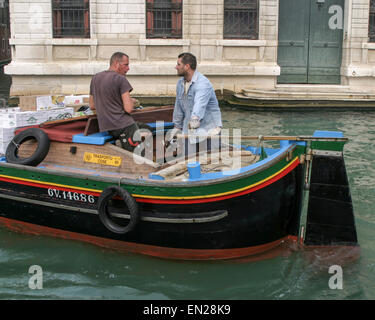 Venice, Province of Venice, ITALY. 7th Oct, 2004. Workers transporting merchandise steer their canal barge on the Grand Canal in Venice. Venice is one of the most popular international tourist destinations. © Arnold Drapkin/ZUMA Wire/Alamy Live News Stock Photo