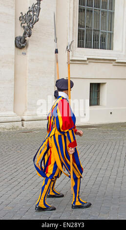 VATICAN CITY, VATICAN - AUGUST 1: Famous Swiss Guard surveil basilica entrance on August 1, 2014 in Vatican. The Papal Guard wit Stock Photo
