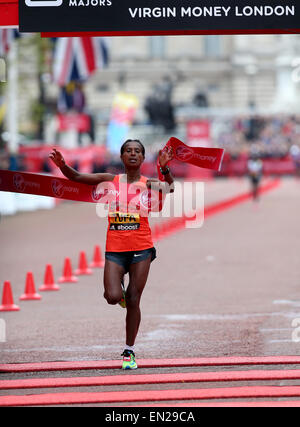 London, Sunday, UK. 26th Apr, 2015. Tigist Tufa of Ethiopia who came first crosses the finish line at the 35th London Marathon, Sunday, April 26, 2015. Tigist Tufa of Ethiopia won the gold with 2 hours 23 minutes and 22 seconds. Credit:  Han Yan/Xinhua/Alamy Live News Stock Photo