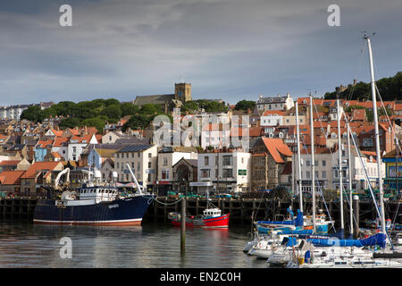 UK, England, Yorkshire, Scarborough, boats moored at Old Harbour quay below old town and St Mary’s church