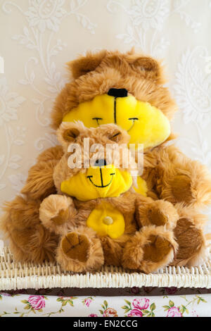 The Shaggy Bears soft cuddly toys sitting on wicker basket - big and little teddy Stock Photo