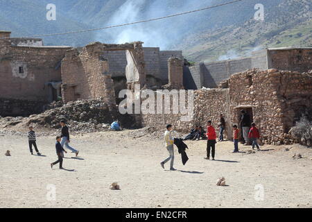 Kids playing football on the streets of the Berber village of Tafgart in the High Atlas Mountains, Morocco Stock Photo