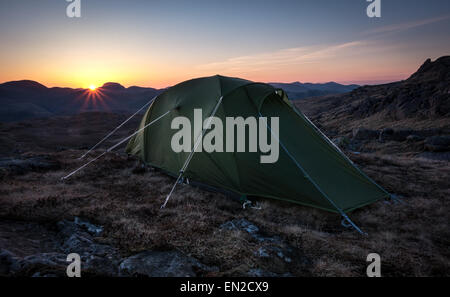 Our tent setup on Harrison Stickle with the sun setting behind Great Gable in the distance. Stock Photo