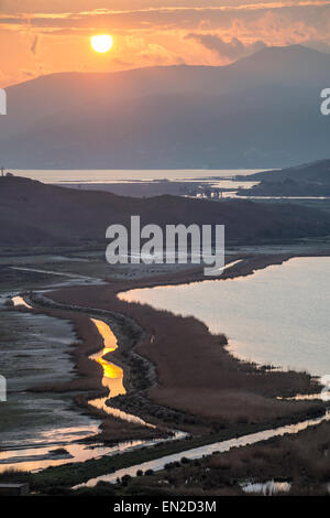 Sunset across the Vrina plain wetlands at Butrint National Park, with the Vivari channel and Butrint in the background, Southern Stock Photo