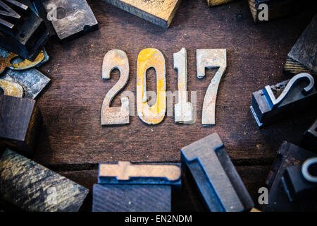 The year 2017 written in rusted metal letters surrounded by vintage wooden and metal letterpress type. Stock Photo