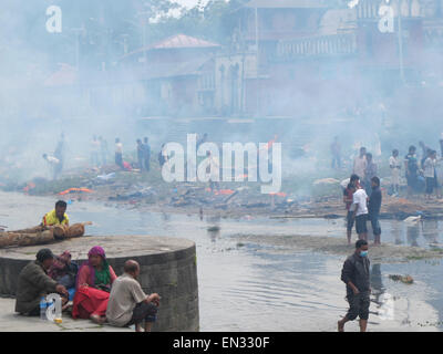 Earthquake Kathmandu Nepal dead bodies on funeral pyres on edge of Bagmati River receiving final Rites Stock Photo