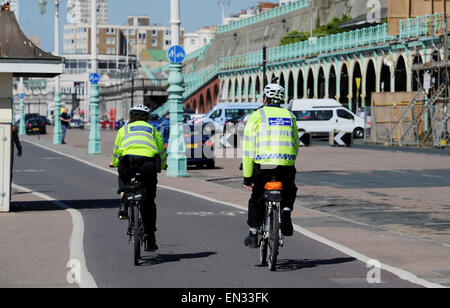 Two Police Community Support Officers cycling along Brighton seafront April 2015 Stock Photo