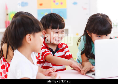 In the kindergarten children are using the computer Stock Photo