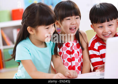 In the kindergarten children are using the computer Stock Photo