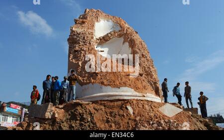 Kathmandu, Nepal. 27th Apr, 2015. People gather around the damaged Dharahara after a massive earthquake in Kathmandu, Nepal, April 27, 2015. A total of 3,218 people had been killed and about 6,500 others injured in the powerful earthquake that struck Nepal at midday Saturday, the authorities said Monday morning. Credit:  Sunil Sharma/Xinhua/Alamy Live News Stock Photo