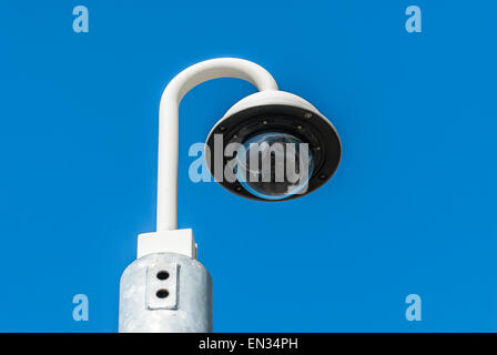 Modern closed circuit tv camera isolated against a blue sky. Stock Photo